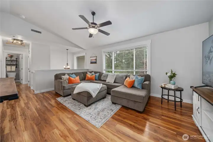 The upper level features the main living area with rich easy care flooring. A large picture window allows natural light to flow through the space.