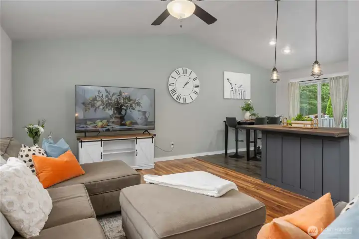 Vaulted ceilings create a more spacious feel with a seamless segue to the kitchen.