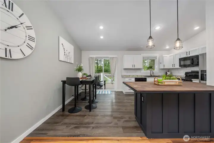 A well-functioning kitchen and dining area with a large slider door to the deck extending your entertainment space to the outdoors.