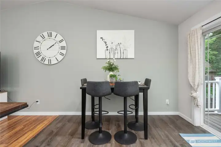 The dining nook sits in front of the slider door overlooking the delightful backyard.