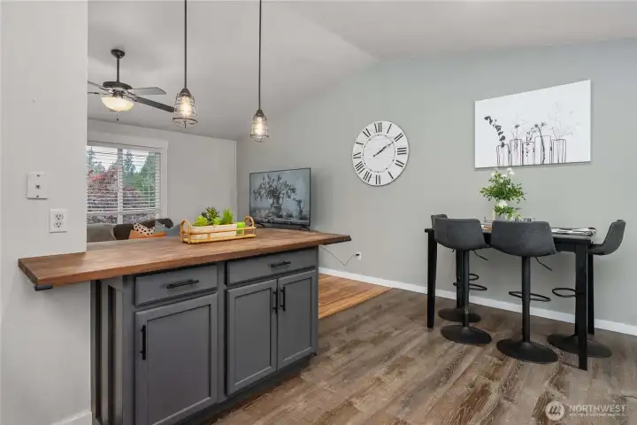 Handsome pendant light fixtures hang above this stylish peninsula.