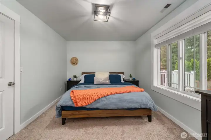 Primary bedroom has a cool and calming palette.