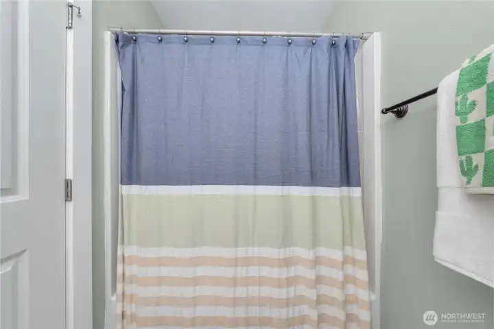 Shower/tub of second bathroom.