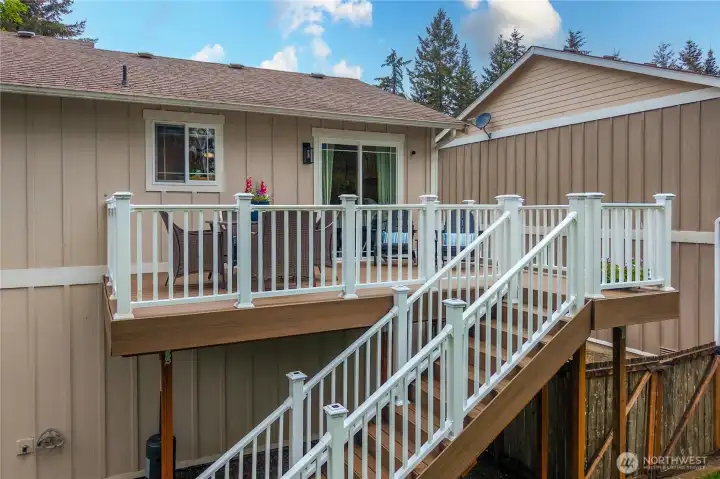 The upper deck has plenty of room for outdoor dining off the kitchen and extra lounge chairs.