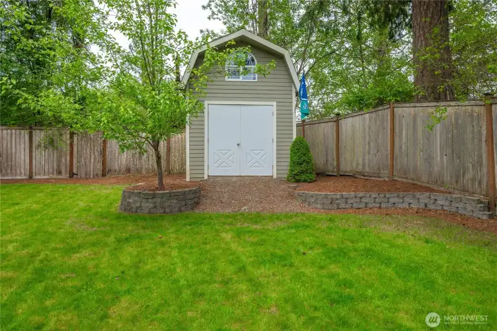 Large shed tastefully situated in the back corner of the yard will house all your outdoor tools and toys.
