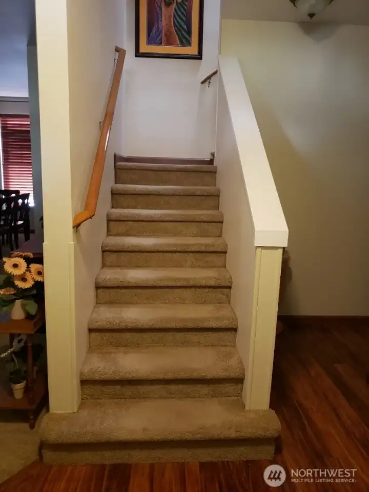 Stairs leading to the two bedrooms and two bathrooms on the second floor