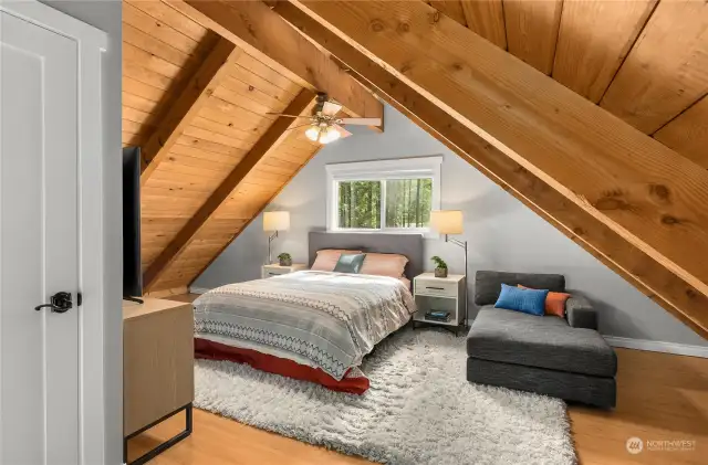 The spacious loft space makes the primary bedroom feel like it's own retreat from the main house.