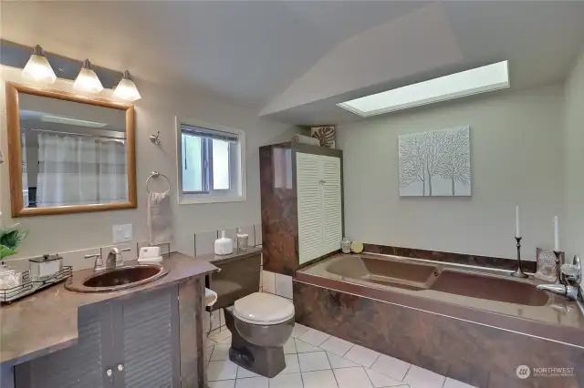 Large primary bathroom with jacuzzi tub.