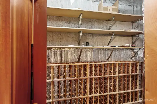 Hidden climate-controlled wine cellar. Hidden behind the billiard cue stick rack.