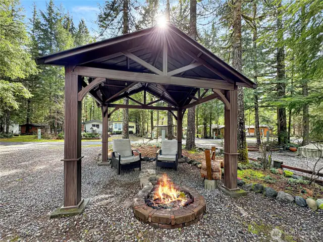 Gorgeous open sided gazebo tht covers the fire pit.