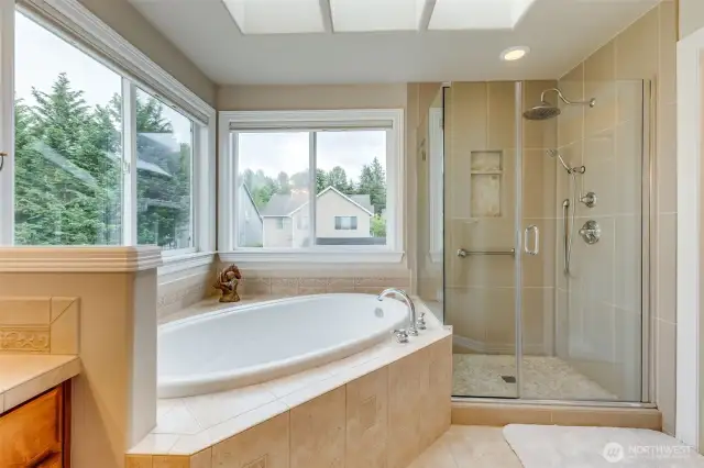 Tile work in primary, 5 pc bath, soaking tub, skylights, natural light.