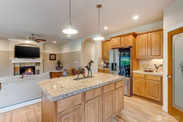 New fridge, kitchen opens to living room. Light and bright natural light.