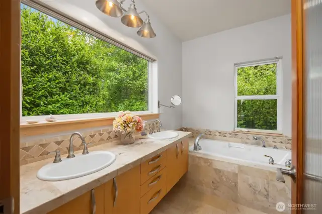 Attached bath for the main floor bedroom, double sinks, large soaking tub and out of view is the shower and walk in closet.
