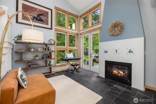 This den/home office is located on the main floor with its own cozy propane fireplace, soaring ceilings and double glass doors leading to a fully fenced back yard with water feature, patio and fireplace.
