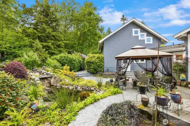 A view of the back patio with room to relax and entertain. The water feature is off to the left.