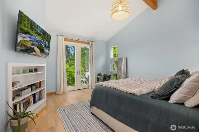 Another look at the bedroom shows the deck access and glass doors for plenty of sunshine.