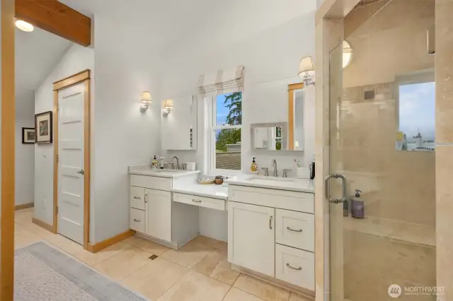The attached bath has in-floor radiant heat, walk-in glass shower, double vanity and walk in closet just beyond the 5 panel wood door