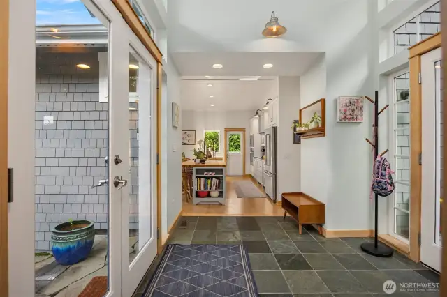 Full glass doors lead you into the slate floor entry, you can access the back patio, the main floor or the upper bedroom wing from this entry.