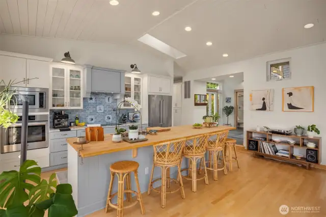 The kitchen is open to the main living/entertaining area. The large butcher block island is a comfortable place to gather for morning coffee