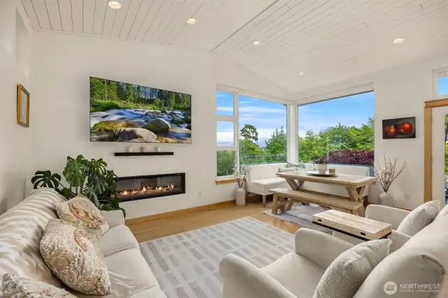 The living room and dining area share the warmth of a propane fire place to relax.