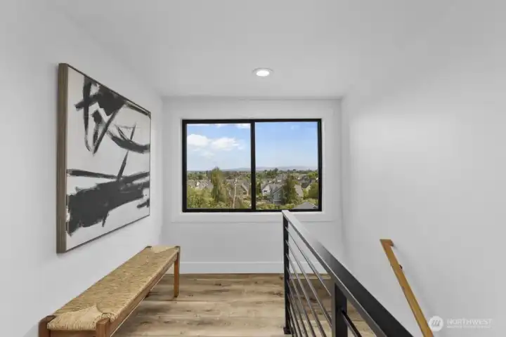 Let's head up to the primary suite! Stunning views from the landing.