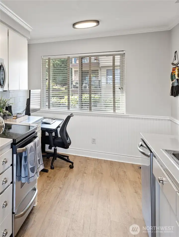 This area off the kitchen can be used for casual dining or additional office space. The large South-facing window fills the room with light and provides outdoor vistas.