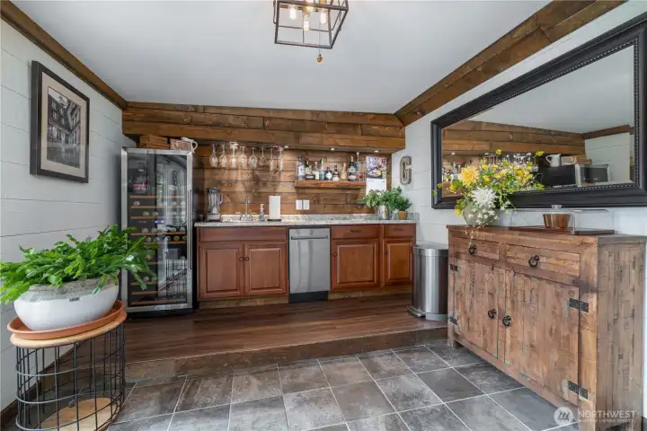 Check out this wine room with wet bar. Includes a beverage refrigerator and a dishwasher