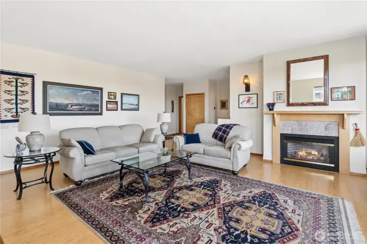Living room with a coat closet door showing, and bedroom doors beyond.