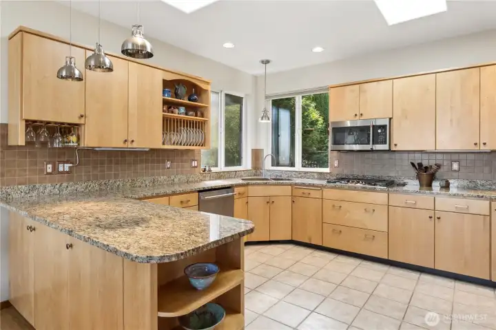 Expansive kitchen has upgraded polished look. Efficient space to cook. Plenty of storage and countertop space. New gas cooktop and dishwasher. Copper sink.