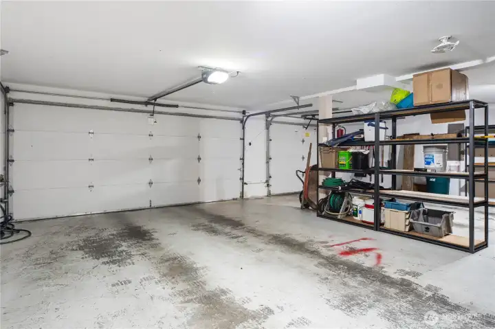 Very large garage with a double garage door and a single garage door.