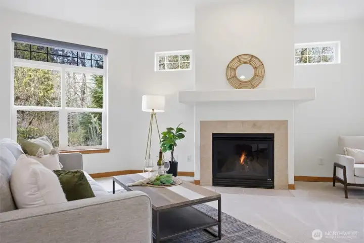 Looking toward the fireplace with the window looking out to the stream and nature beyond.