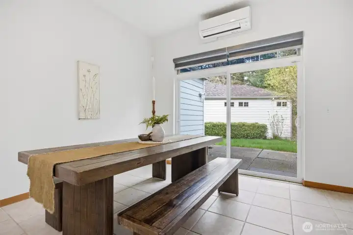 The dining room opens out to the large concrete patio that takes in nature along the stream.