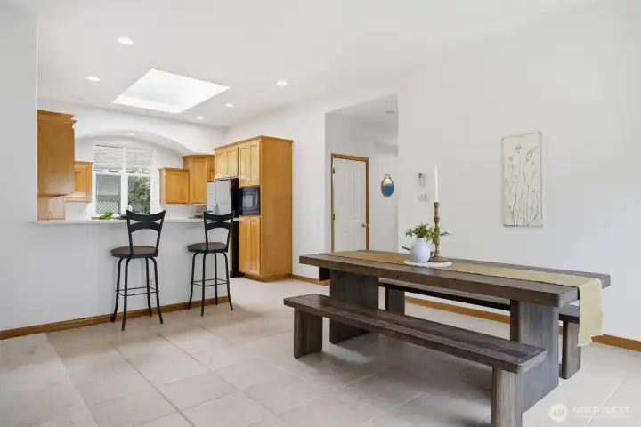 The floor plan is open and the sunlight streams in through the windows and skylights.