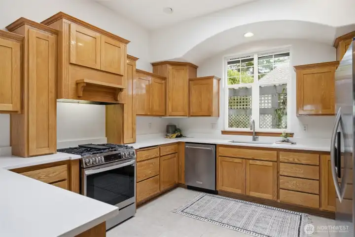 The 5-burner gas range has a concealed vent hood.