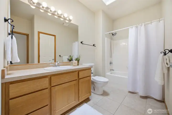 The full bath is adjacent to the 2nd bedroom and near the den/office at the front entry.