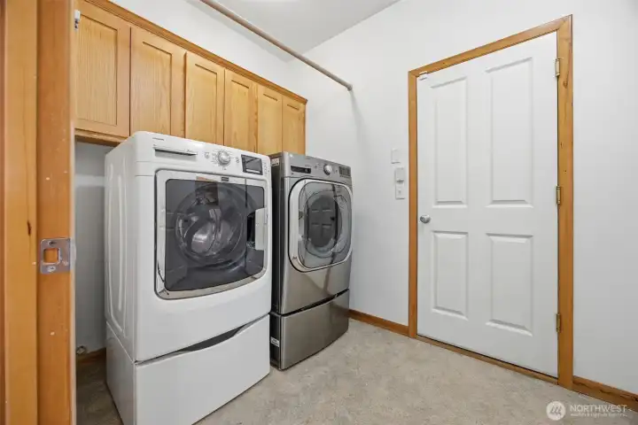 The laundry room opens to the zero-clearance threshold at the attached garage.