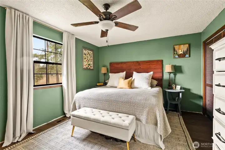 Primary bedroom with ceiling fan.