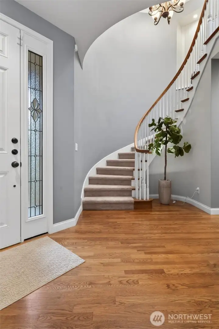 Dramatic curved staircase creates architectural elegance.