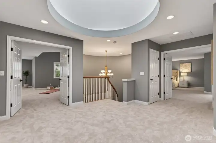 Impressive upper landing illuminated by an overhead skylight.