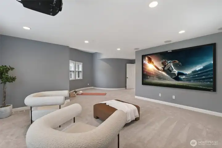Movie theater includes projector and theater screen. Prewired surround sound elevates the entertainment experience.