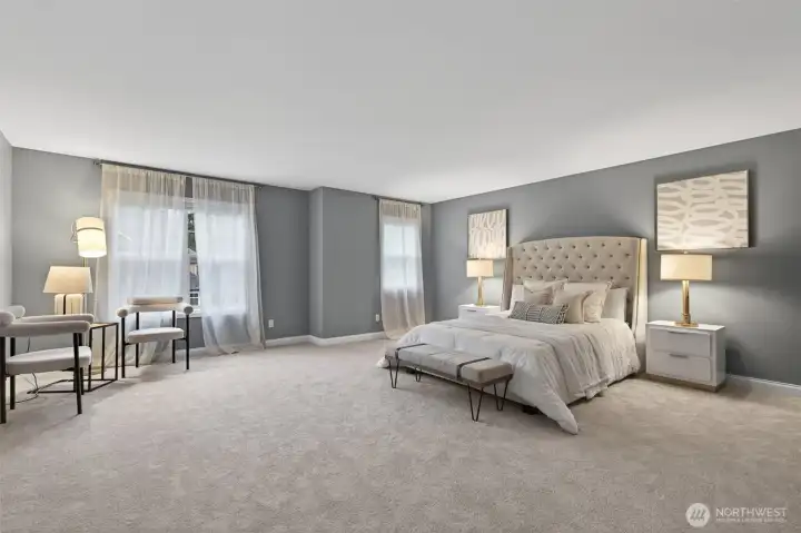 Spacious primary bedroom with sitting area flexibility.