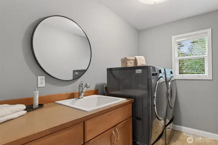 Dedicated laundry room with convenient sink.