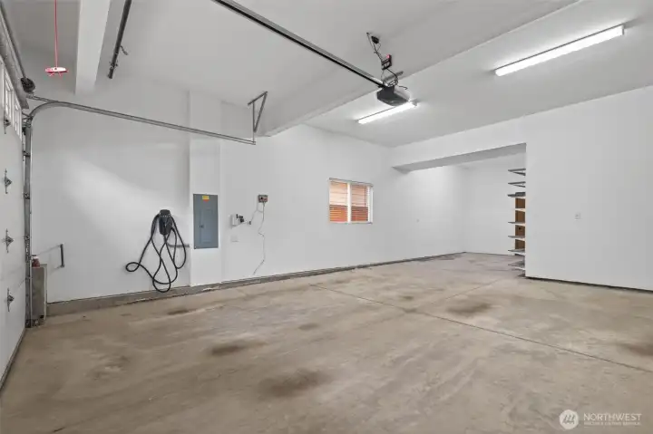 Spacious 3-car garage offers exceptional storage and parking. EV charger adds convenience for modern living.