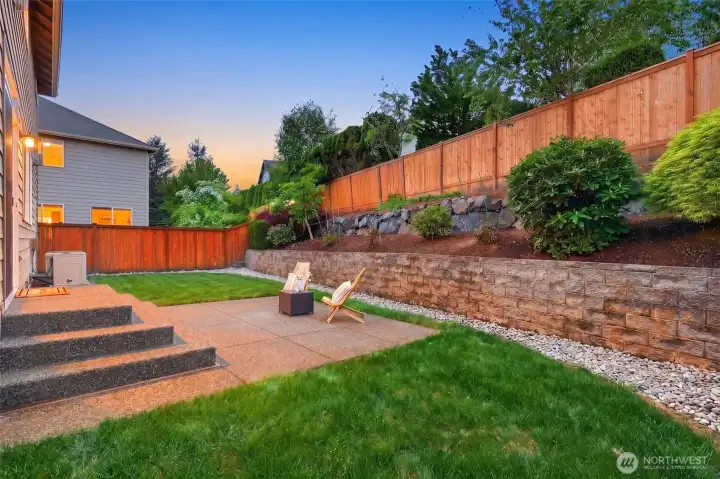 Paved patio creates the perfect outdoor gathering space.