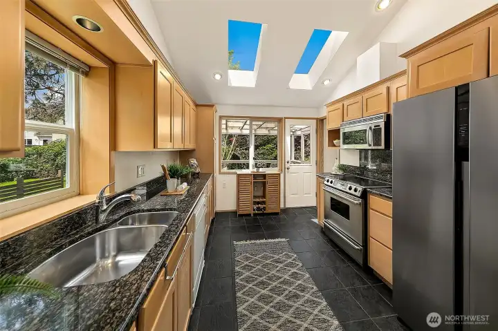 Updated kitchen with soaring ceiling and skylights