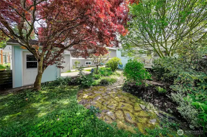 Flagstone patio shaded by beautiful mature trees