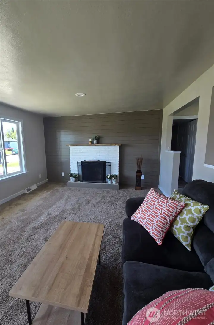 living room with wood burning fireplace