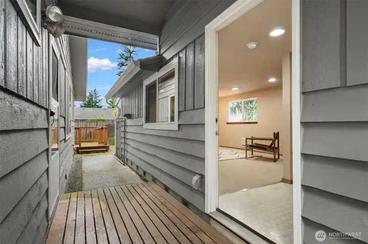 the covered breezeway leading to the bonus room out back.