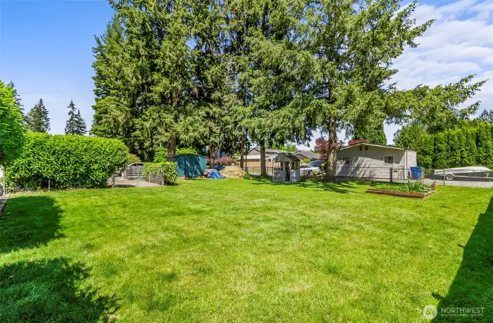 Huge fully fenced backyard with gated access, offering privacy, flexibility, and plenty of room to add a shop.