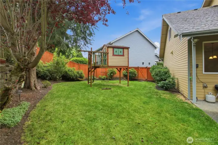 Check out this backyard with sweet playhouse
